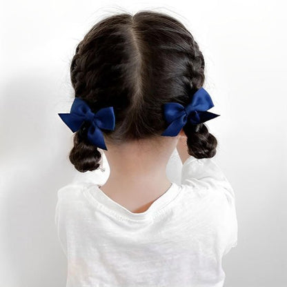 Pince-à-cheveux-bleue-sur-deux-tresses-enfant-vue-de-dos-style-soigne