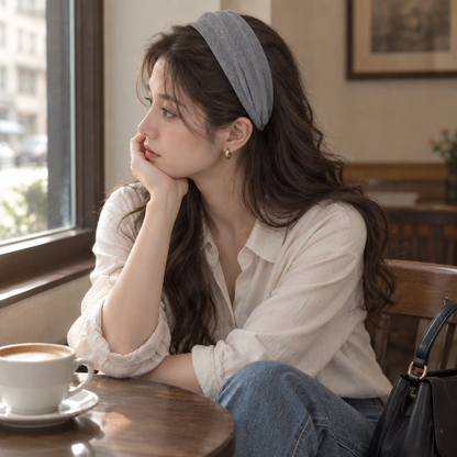Serre tête chic gris porte par une femme assise pres de la fenetre d un cafe