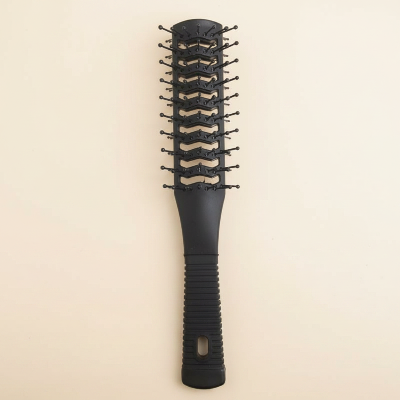 Brosse à cheveux démêlante noire double-face fond beige