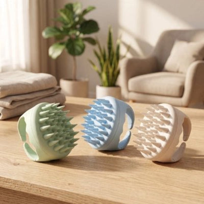 Brosse massage cuir chevelu​ trois couleurs vert bleu blanc sur une table