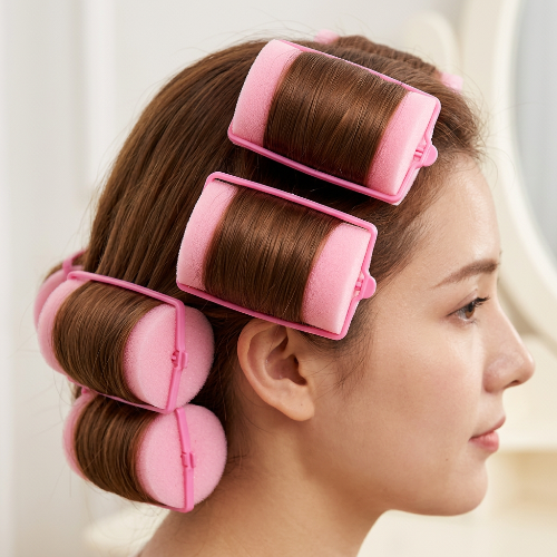 Rrouleaux de cheveux en mousse roses sur cheveux enroules
